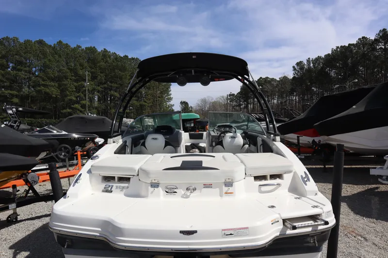 Slide: The Image of 2017 Chaparral 21 H2O Sport boat displayed outdoors with trees in the background. - 4