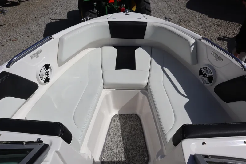Slide: The Image of 2017 Chaparral 21 H2O Sport boat interior with white seating and speakers. - 5