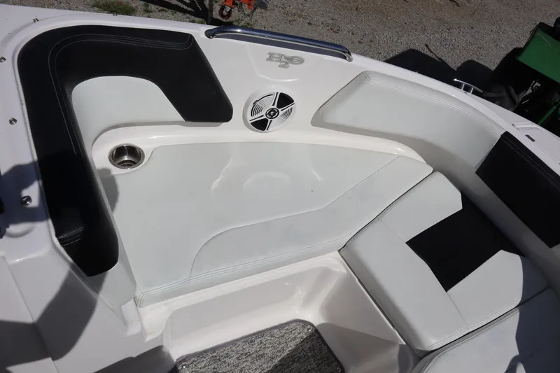Slide: The Image of 2017 Chaparral 21 H2O Sport boat interior with white and black seating and speaker. - 6
