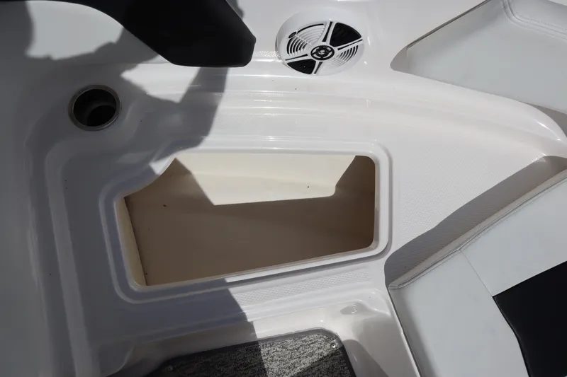 Slide: The Image of 2017 Chaparral 21 H2O Sport boat storage compartment with speaker and cup holder. - 7