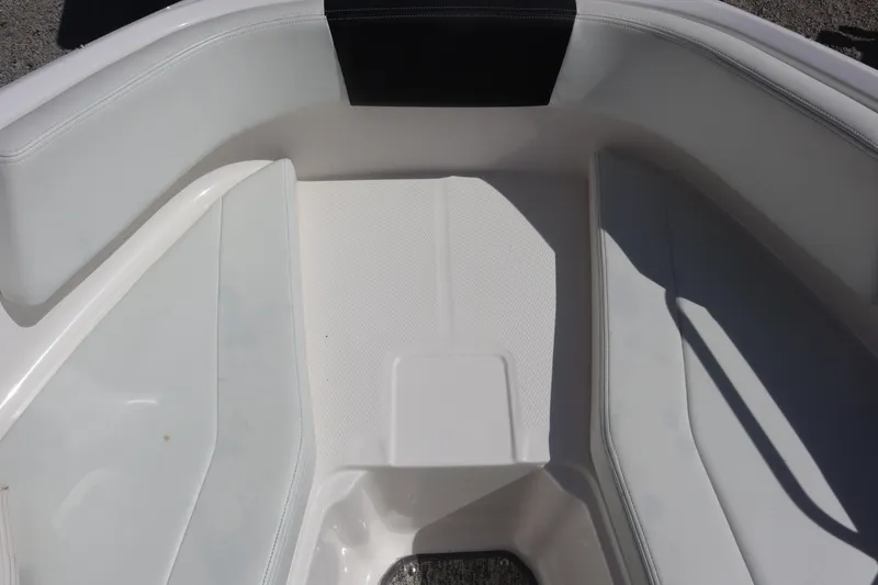 Slide: The Image of 2017 Chaparral 21 H2O Sport boat interior, featuring white seating and flooring. - 8