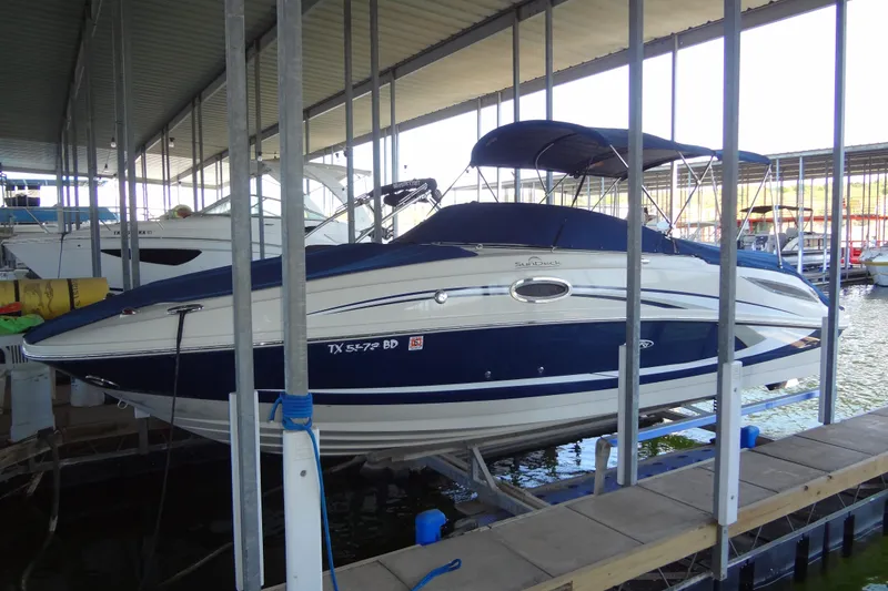 Slide: The Image of 2010 Sea Ray 260 Sundeck boat docked in a marina. - 11