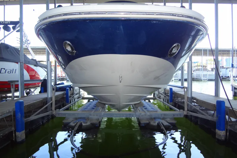 Slide: The Image of 2010 Sea Ray 260 Sundeck boat docked in marina, front view. - 14