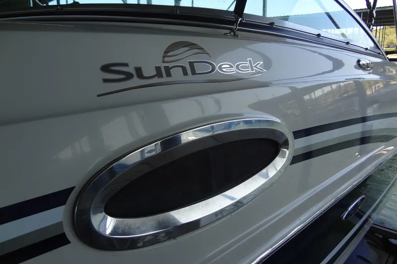 Slide: The Image of 2010 Sea Ray 260 Sundeck boat side view with logo and sleek design. - 16