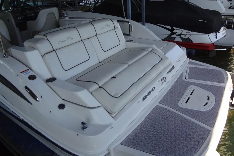 Slide: The Image of 2010 Sea Ray 260 Sundeck boat with cushioned seating and swim platform. - 17
