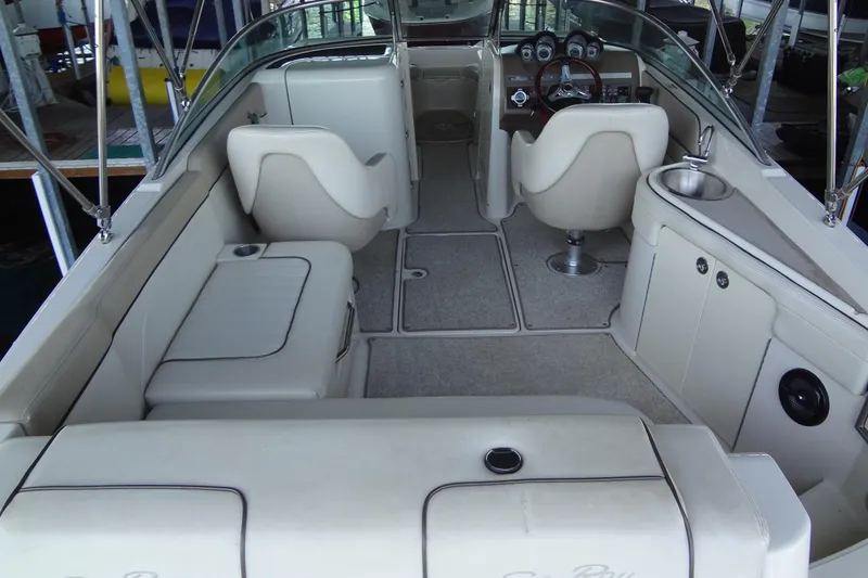 Slide: The Image of 2010 Sea Ray 260 Sundeck interior with beige seating and dashboard. - 21