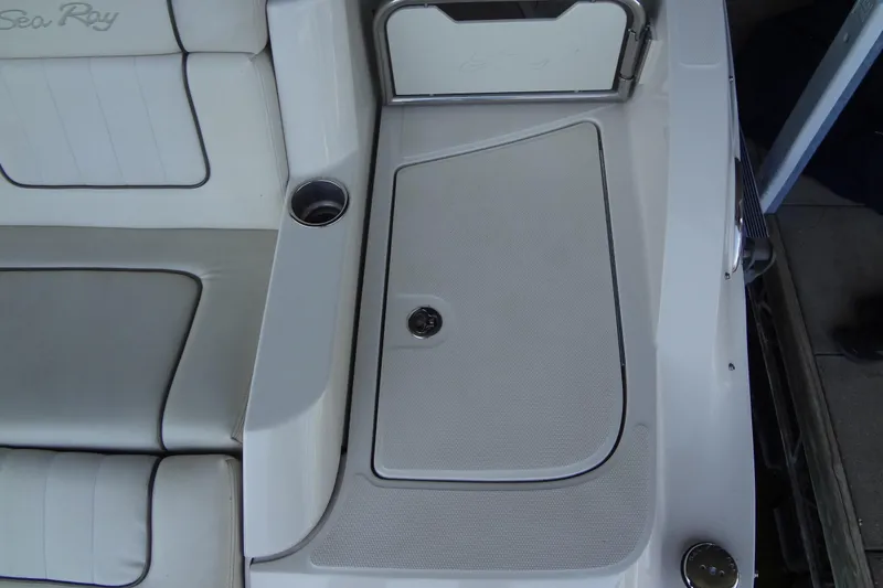 Slide: The Image of 2010 Sea Ray 260 Sundeck interior with seating and storage compartment. - 22