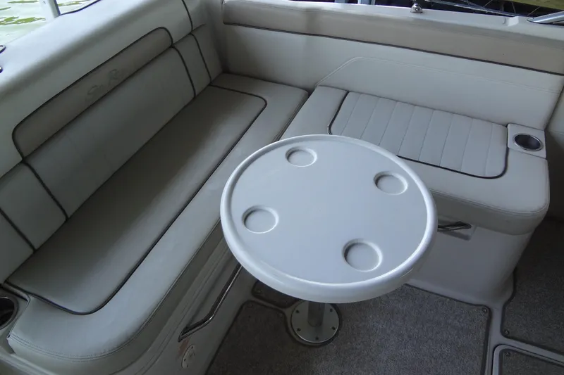 Slide: The Image of Interior seating of 2010 Sea Ray 260 Sundeck with round table and cup holders. - 25