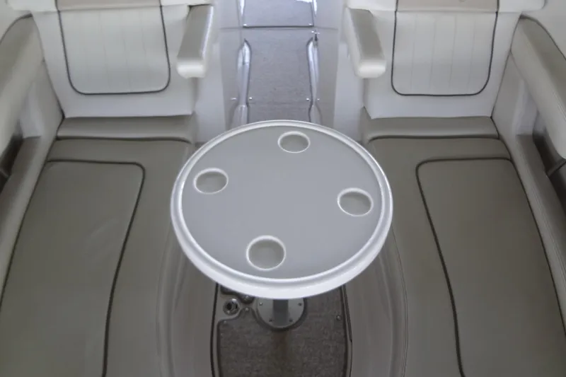 Slide: The Image of Interior seating of 2010 Sea Ray 260 Sundeck with round table and cup holders. - 32