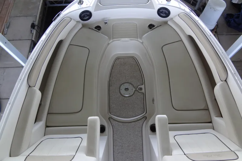 Slide: The Image of 2010 Sea Ray 260 Sundeck interior with beige seating and carpeted floor. - 35