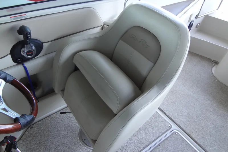 Slide: The Image of Captain's seat on 2010 Sea Ray 260 Sundeck boat, featuring plush upholstery and steering wheel. - 38