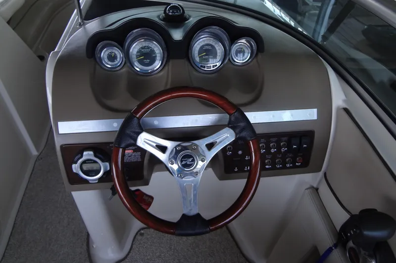 Slide: The Image of Dashboard of a 2010 Sea Ray 260 Sundeck boat with gauges and steering wheel. - 39