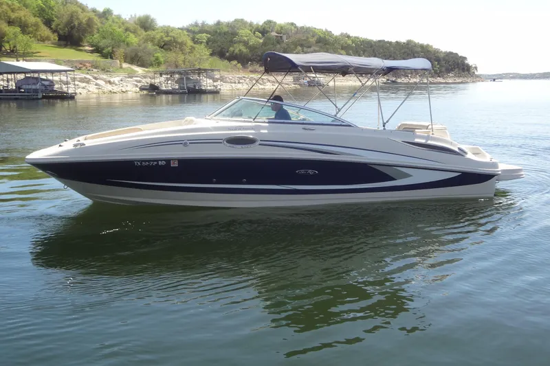 Slide: The Image of 2010 Sea Ray 260 Sundeck boat on calm lake with scenic background. - 4