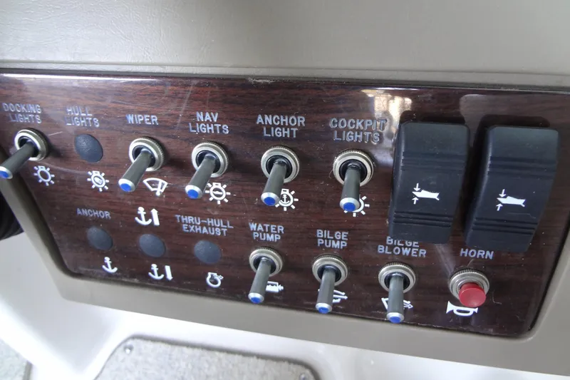 Slide: The Image of Control panel of a 2010 Sea Ray 260 Sundeck boat with various switches. - 43