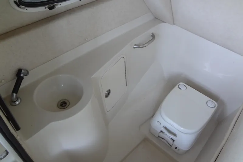 Slide: The Image of Compact bathroom in 2010 Sea Ray 260 Sundeck boat with sink and portable toilet. - 46
