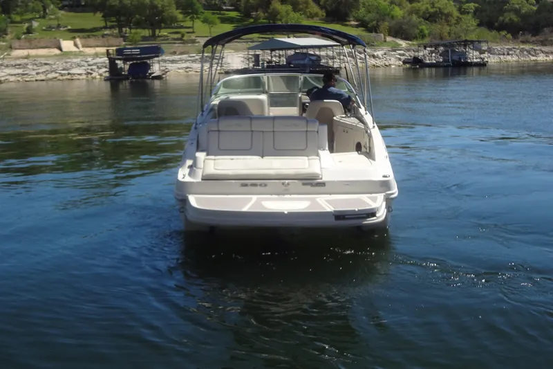 Slide: The Image of 2010 Sea Ray 260 Sundeck boat cruising on a calm lake. - 7