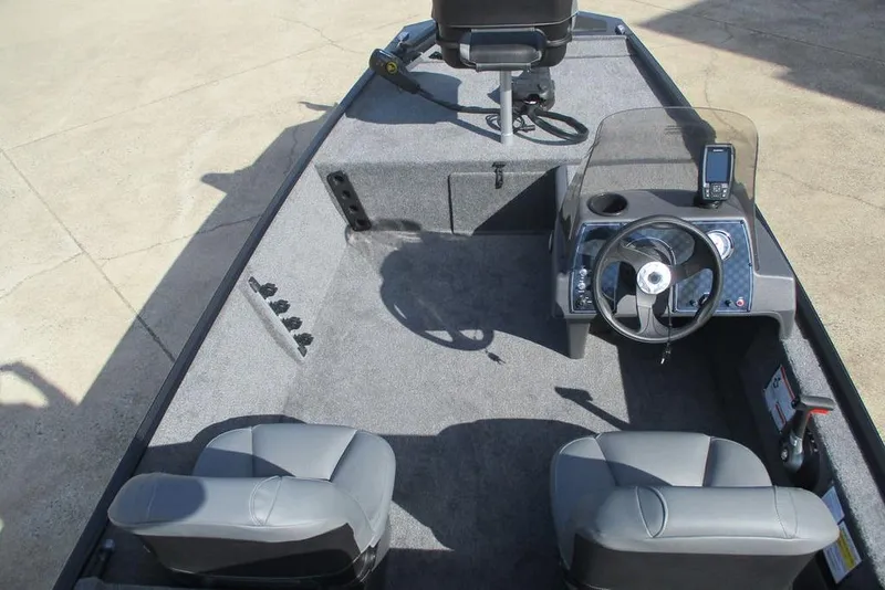 Slide: The Image of 2026 Tracker Bass Tracker Classic XL boat interior with steering console and seating. - 11
