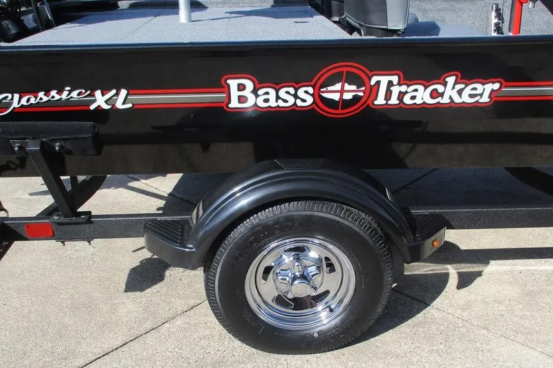 Slide: The Image of 2026 Tracker Bass Tracker Classic XL boat trailer with logo and wheel detail. - 4