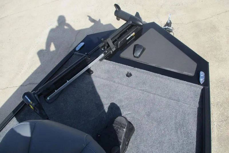 Slide: The Image of 2026 Tracker Bass Tracker Classic XL boat deck with trolling motor and carpeted surface. - 7