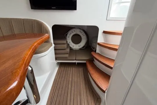 Slide: The Image of Interior of 2012 Shearline Express Fisherman boat with wooden stairs and seating area. - 12