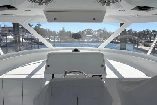 Slide: The Image of Interior view of 2012 Shearline Express Fisherman boat cockpit with marina background. - 15