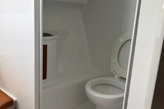 Slide: The Image of 2012 Shearline Express Fisherman boat bathroom with white toilet and compact design. - 22