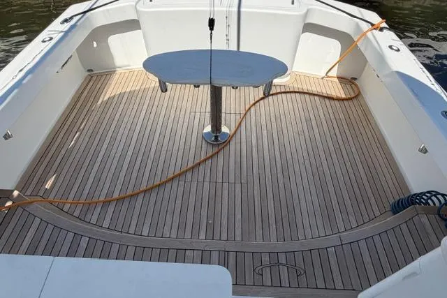 Slide: The Image of 2012 Shearline Express Fisherman boat deck with wooden flooring and central table. - 4