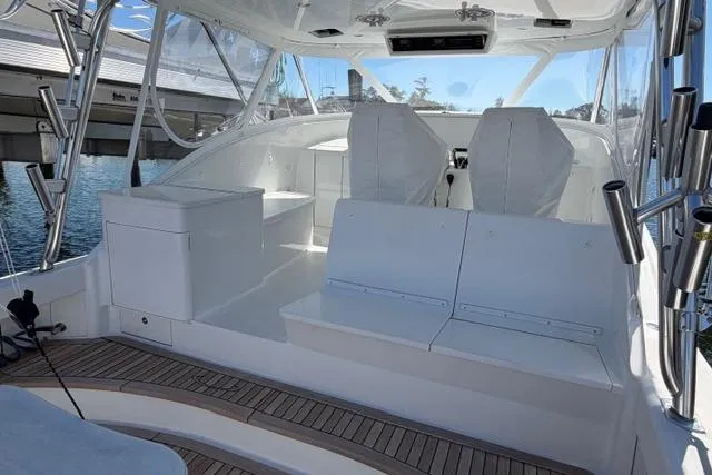 Slide: The Image of 2012 Shearline Express Fisherman boat interior with white seating and wooden deck. - 5