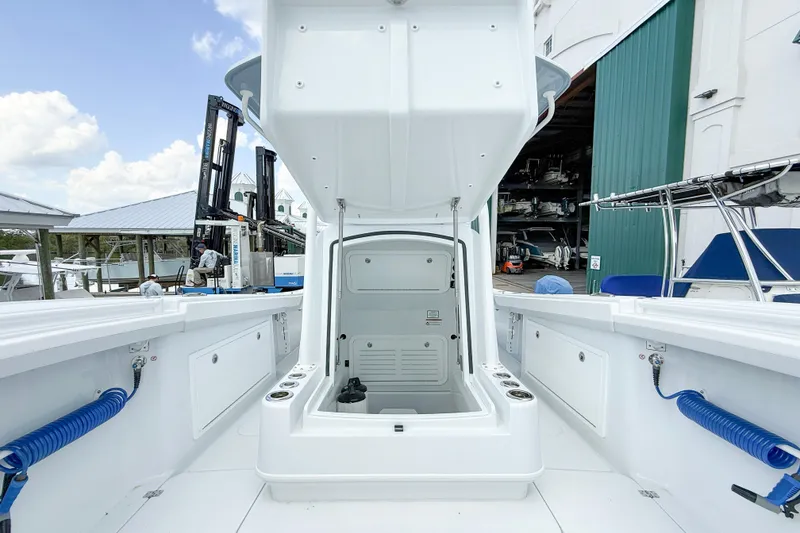 Slide: The Image of 2024 Yellowfin 34 Offshore boat interior with storage compartment, docked at marina. - 10