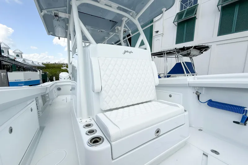 Slide: The Image of 2024 Yellowfin 34 Offshore boat interior with white seating and modern design. - 12