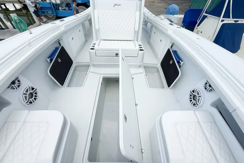 Slide: The Image of 2024 Yellowfin 34 Offshore boat interior with seating and storage compartments. - 14