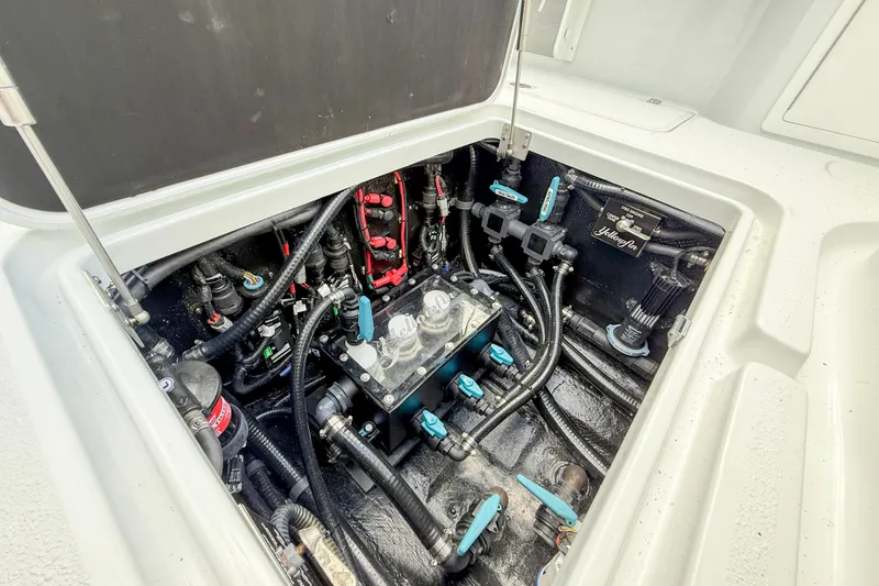 Slide: The Image of 2024 Yellowfin 34 Offshore boat engine compartment with complex wiring and components. - 29