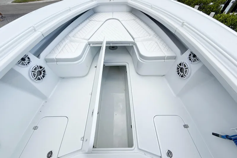 Slide: The Image of 2024 Yellowfin 34 Offshore boat interior with seating and storage compartments. - 13