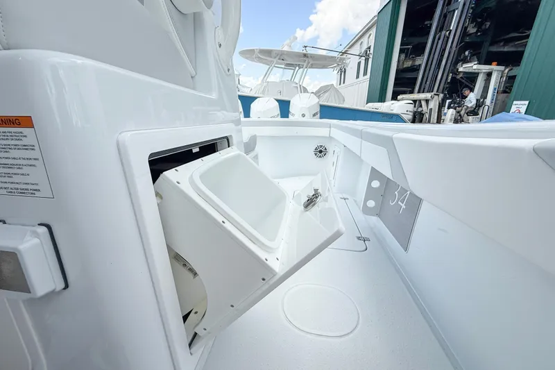 Slide: The Image of 2024 Yellowfin 34 Offshore boat interior with storage compartment open. - 16