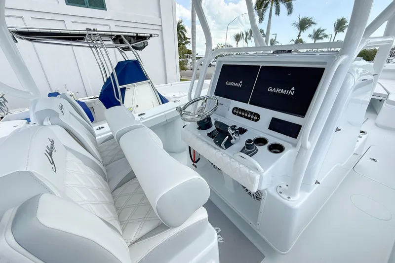 Slide: The Image of 2024 Yellowfin 34 Offshore boat cockpit with Garmin displays and luxurious seating. - 2