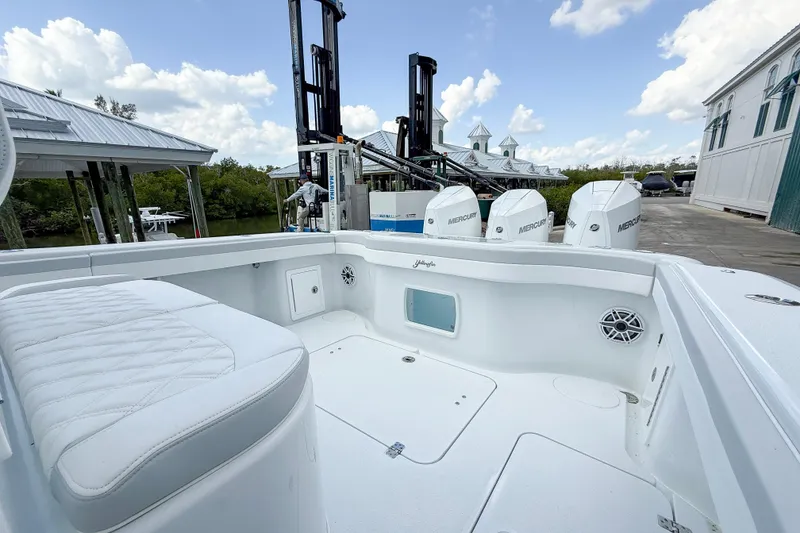 Slide: The Image of 2024 Yellowfin 34 Offshore boat with Mercury engines, docked under a clear sky. - 25