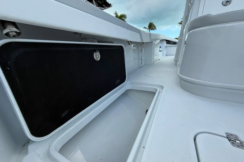 Slide: The Image of 2024 Yellowfin 34 Offshore boat deck with open storage compartment. - 26