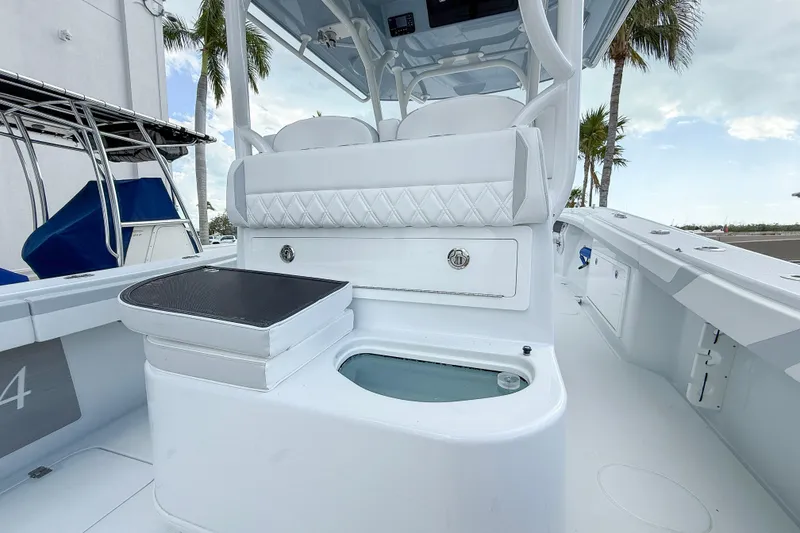 Slide: The Image of 2024 Yellowfin 34 Offshore boat interior with seating and storage, featuring sleek white design. - 27