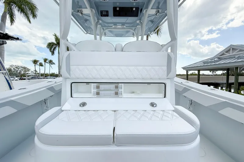 Slide: The Image of 2024 Yellowfin 34 Offshore boat interior with white seating and storage compartments. - 28