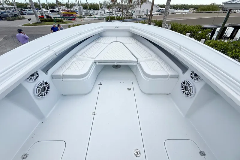 Slide: The Image of 2024 Yellowfin 34 Offshore boat interior with white seating and speakers. - 7