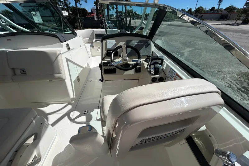 Slide: The Image of 2018 Boston Whaler 270 Vantage boat interior with steering wheel and seating. - 11