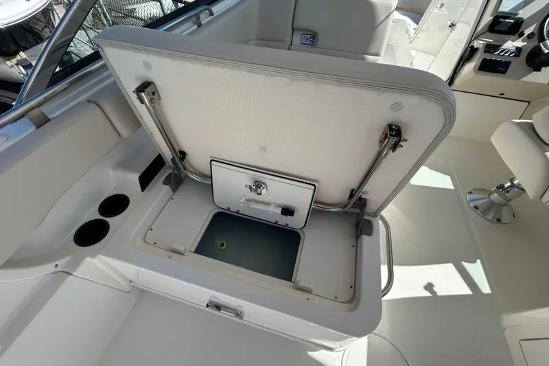 Slide: The Image of 2018 Boston Whaler 270 Vantage boat interior with open storage compartment and seating. - 14