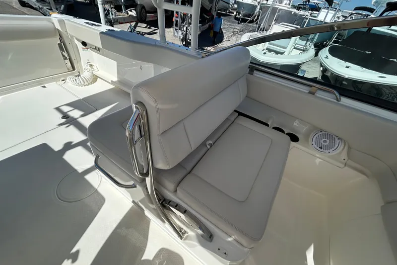 Slide: The Image of 2018 Boston Whaler 270 Vantage boat interior with cushioned seating and speaker. - 15