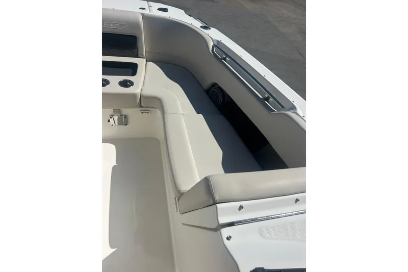 Slide: The Image of 2018 Boston Whaler 270 Vantage boat interior with cushioned seating and cup holders. - 18
