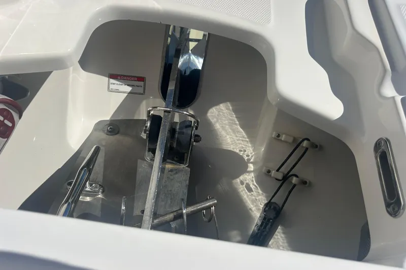Slide: The Image of Anchor compartment of 2018 Boston Whaler 270 Vantage boat, featuring safety warning label. - 19