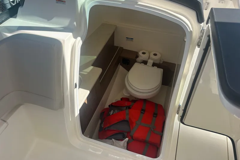 Slide: The Image of 2018 Boston Whaler 270 Vantage boat interior with toilet and life jackets. - 20