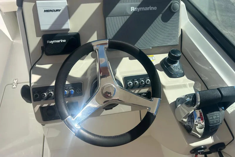 Slide: The Image of Steering console of 2018 Boston Whaler 270 Vantage with Raymarine and Mercury controls. - 22
