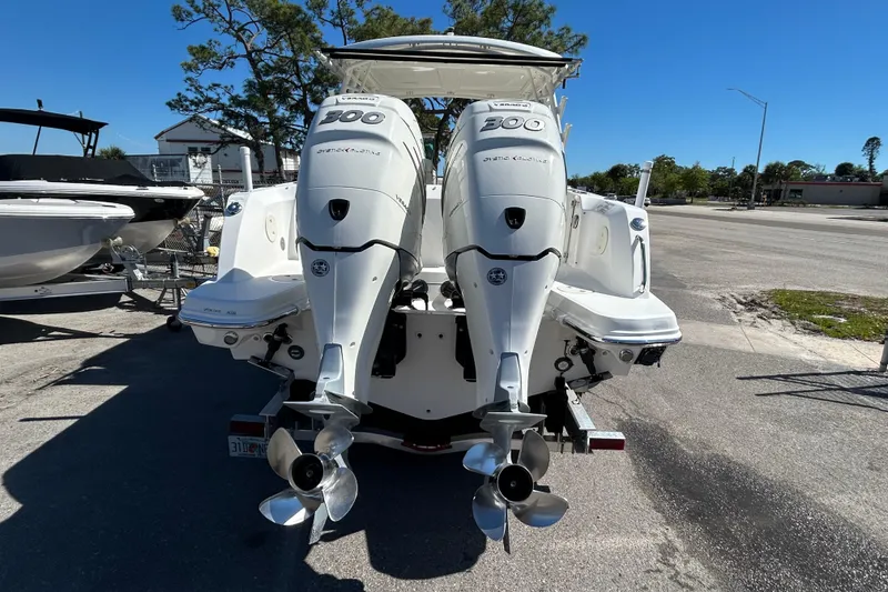 Slide: The Image of 2018 Boston Whaler 270 Vantage with twin 300 horsepower engines, parked on a sunny day. - 5