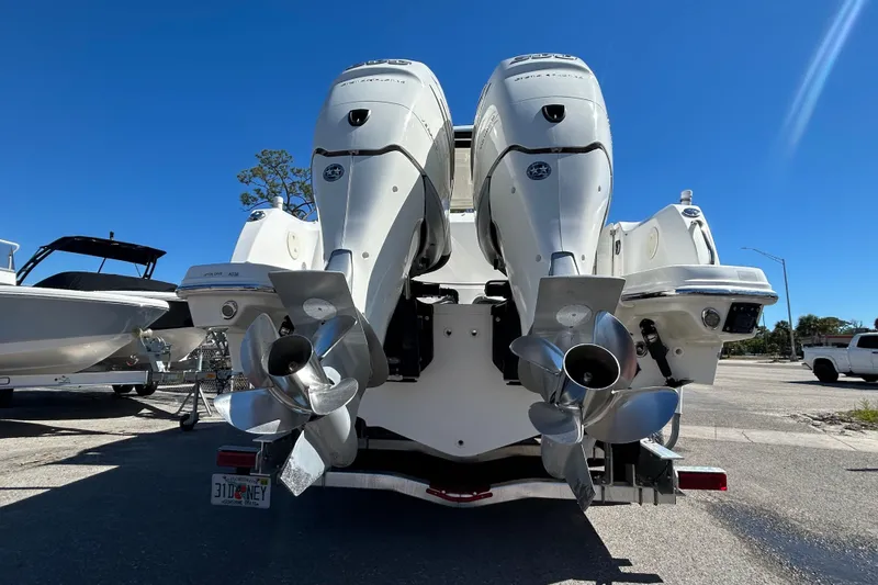 Slide: The Image of 2018 Boston Whaler 270 Vantage with dual outboard engines, parked on a sunny day. - 6