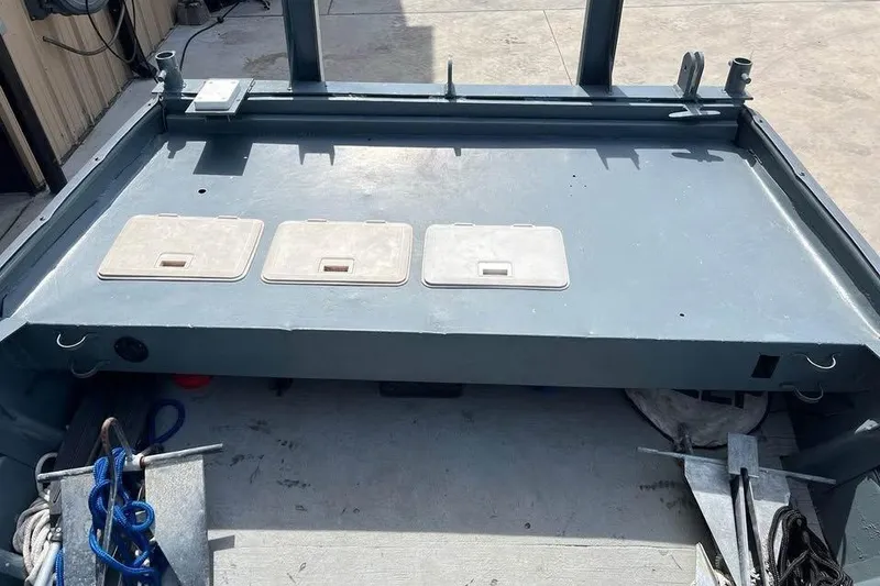 Slide: The Image of 1999 Aluminum Boat interior with storage compartments and equipment. - 12